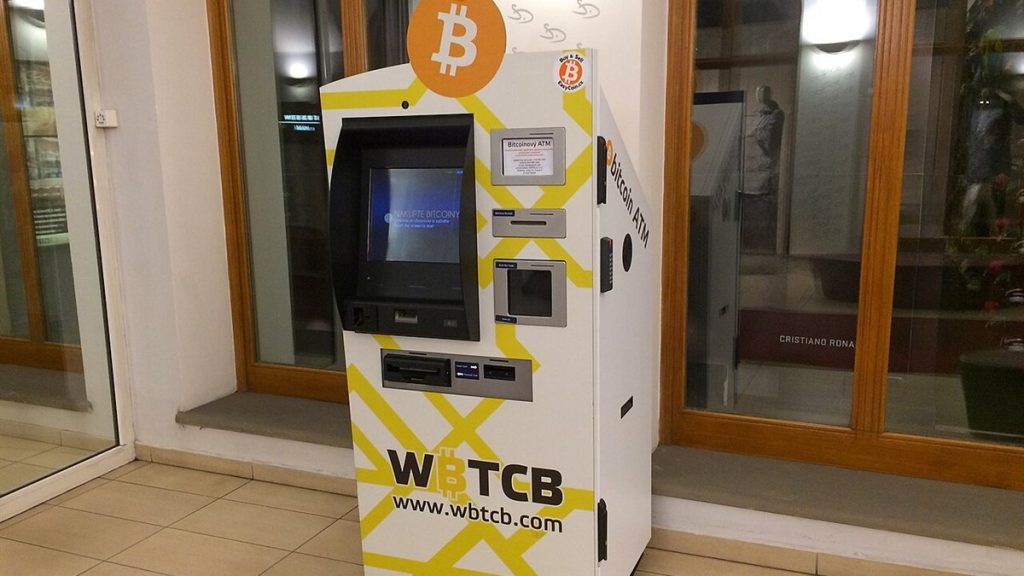 A bitcoin ATM machine in a building lobby