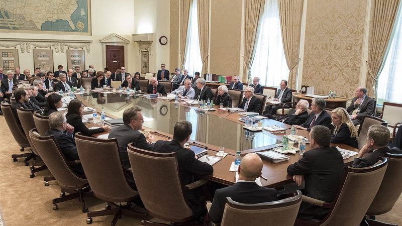Officials seated around the table at a Federal Open Market Committee meeting