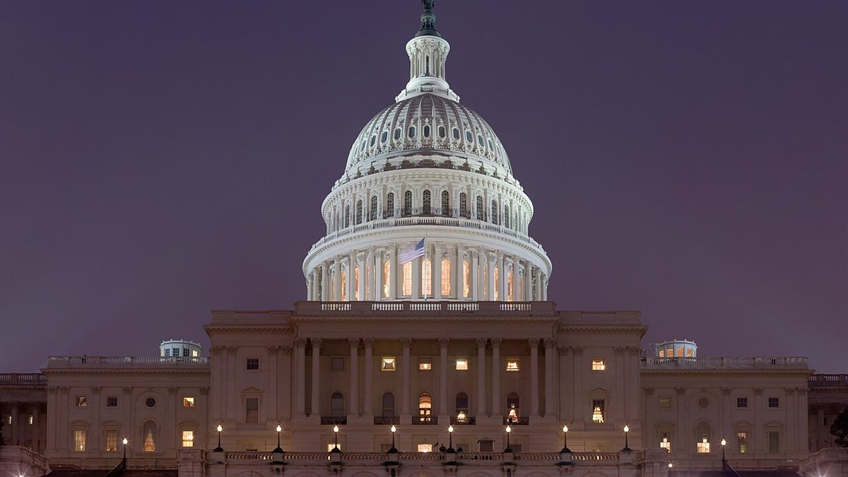 The United States Capitol building illuminated at dusk